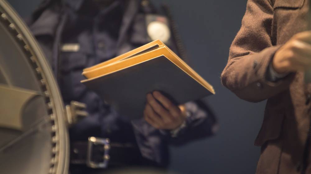 A police officer holds a folder