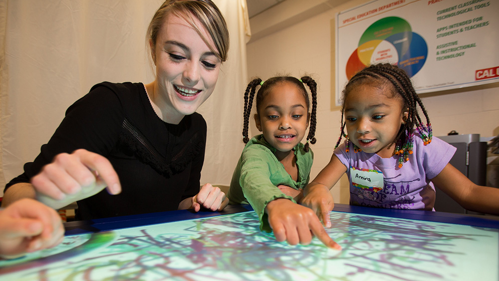 A PennWest California student teaches children in a classroom.