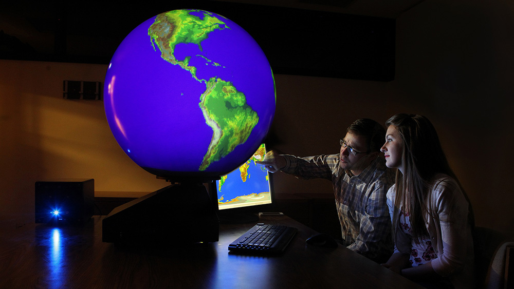Meterology students use a digital globe to simulate weather patterns.