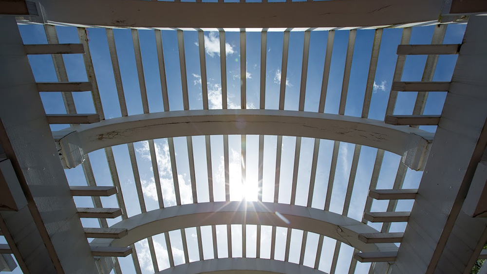 A pergola in the sun on campus gives students places to feel at home.